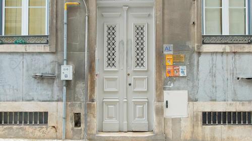 a white door on the side of a building at Glória 10 in Lisbon