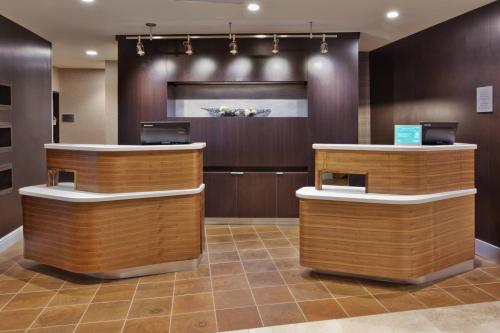 a lobby of a hotel with two reception desks at Courtyard by Marriott Greenville Mauldin in Greenville