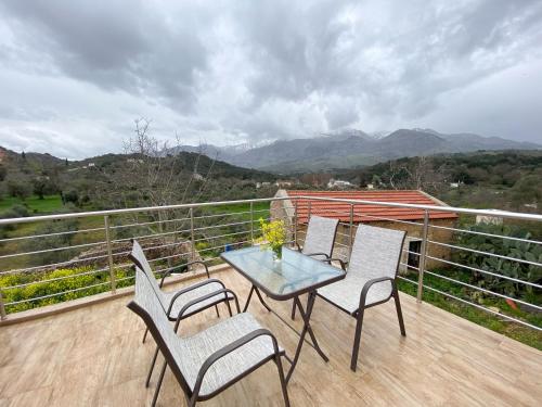 a patio with a table and chairs on a balcony at Pulchra Campis,Private Pool,Wifi,Parking in Nerokoúros