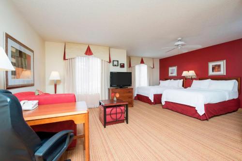 a hotel room with two beds and a desk at Residence Inn Kalamazoo East in Kalamazoo