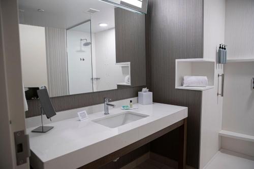 a bathroom with a sink and a mirror at Courtyard by Marriott Greenville Mauldin in Greenville
