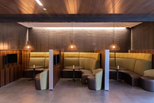 a restaurant with couches and tables and lights at Courtyard by Marriott Greenville Mauldin in Greenville