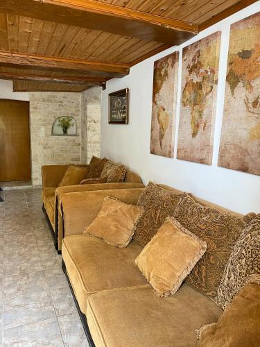 a living room with couches and maps on the wall at Pulchra Campis,Private Pool,Wifi,Parking in Nerokoúros