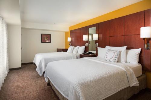 two beds in a hotel room with white sheets at Residence Inn Dayton North in Dayton