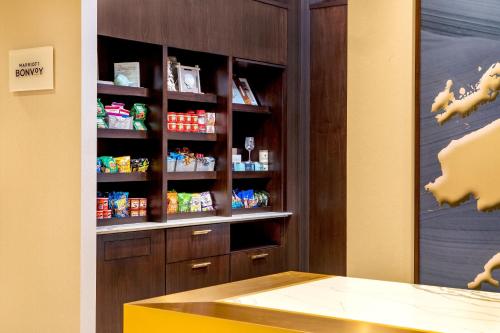 a kitchen with a pantry with food on shelves at SpringHill Suites by Marriott Boston Logan Airport Revere Beach in Revere