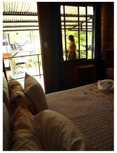 a dog laying on a bed looking out a window at Terrazas del Golfo in La Palma
