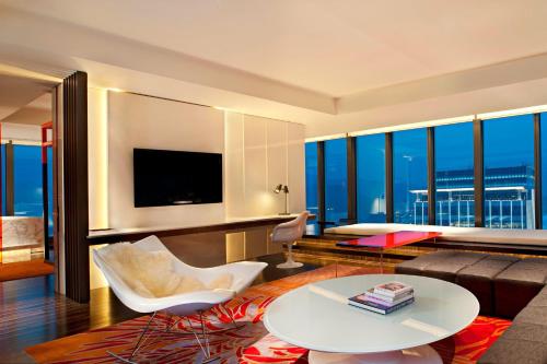 a living room with a couch and a table at W Taipei in Taipei
