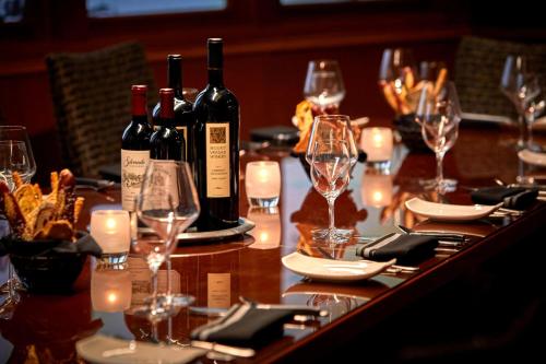 a long table with wine bottles and glasses on it at Los Angeles Airport Marriott in Los Angeles