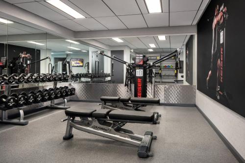 a gym with rows of dumbbells and weights at Los Angeles Airport Marriott in Los Angeles