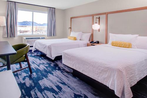 a hotel room with two beds and a window at Fairfield Inn & Suites by Marriott Boulder Broomfield/Interlocken in Broomfield