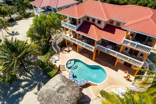 an aerial view of a house with a swimming pool at Villa 99-Beachfront-Pool-Luxury Villa in Placencia Village