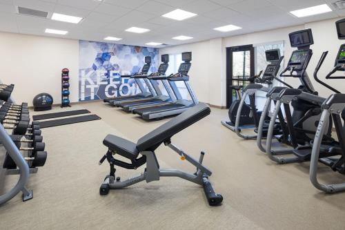 a gym with several treadmills and cardio machines at SpringHill Suites by Marriott Denver Airport in Denver