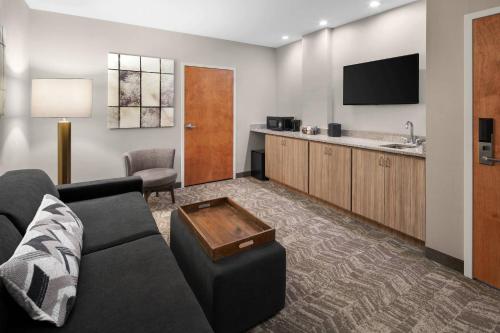 a living room with a couch and a tv at SpringHill Suites by Marriott Denver Airport in Denver