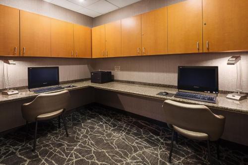 a room with two desks with two computers on them at SpringHill Suites by Marriott Denver Airport in Denver