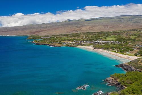 an aerial view of a beach with blue water at Mauna Kea Beach Hotel, Autograph Collection in Hapuna Beach