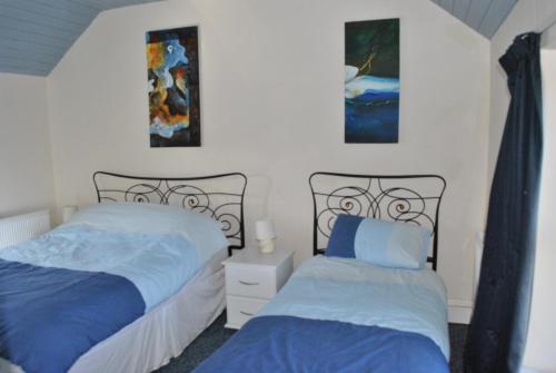 A bed or beds in a room at Douglas Lodge Holiday Homes