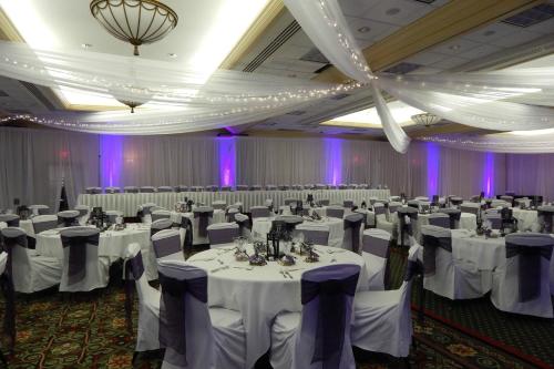 a large banquet hall with white tables and chairs at DoubleTree by Hilton Minneapolis Airport, MN in Bloomington