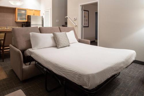 a bed in a room next to a couch at Residence Inn by Marriott Las Vegas Convention Center in Las Vegas