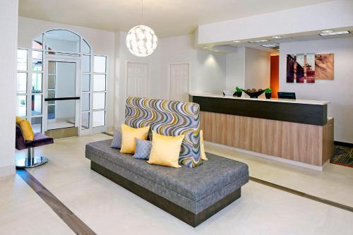 a living room with a chair and a counter at Residence Inn by Marriott Naples in Naples