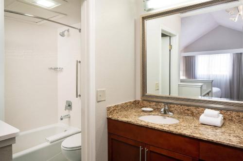 a bathroom with a sink and a mirror at Residence Inn by Marriott Las Vegas Convention Center in Las Vegas