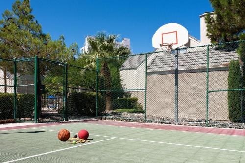 two balls on a tennis court with a basketball hoop at Residence Inn by Marriott Las Vegas Convention Center in Las Vegas