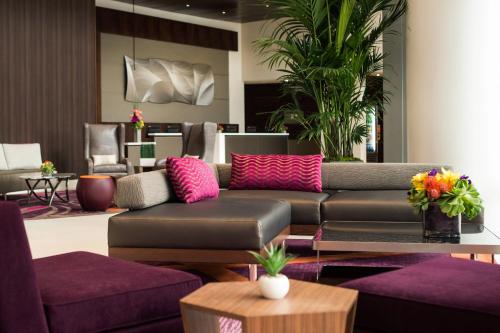 a living room with a couch and purple furniture at Courtyard by Marriott Los Angeles L.A. LIVE in Los Angeles