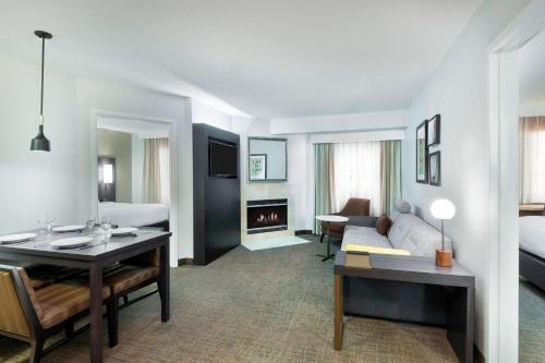 a hotel room with a bed and a living room at Residence Inn Tampa Sabal Park/Brandon in Tampa