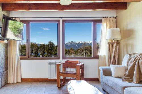 a living room with a large window with a mountain view at BOG Langreo in Villa La Angostura