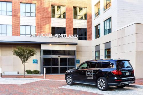 a black car parked in front of a building at AC Hotel by Marriott Portland Downtown/Waterfront, ME in Portland