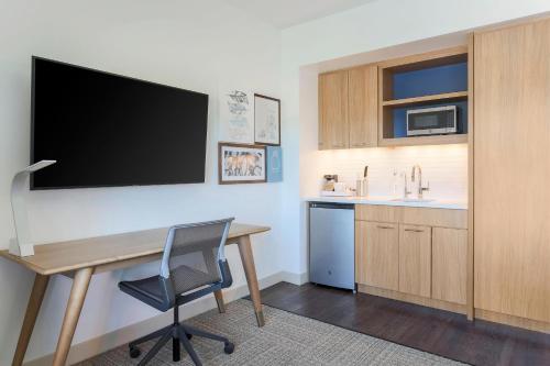 a room with a desk and a tv on a wall at Element Ontario Rancho Cucamonga in Ontario