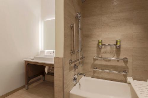 a bathroom with a shower with a tub and a sink at Element Ontario Rancho Cucamonga in Ontario