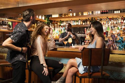 a group of people sitting at a bar at Moxy Austin - University in Austin