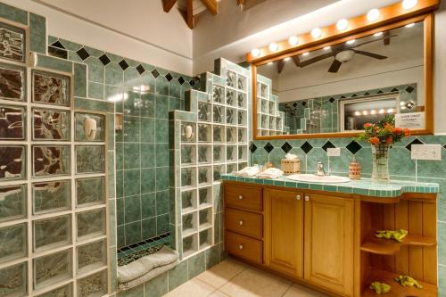 a bathroom with a sink and a shower with glass walls at Villa 99-Beachfront-Pool-Luxury Villa in Placencia Village