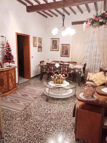 a living room with a christmas tree and a table at Casa Tarrini in Chianni