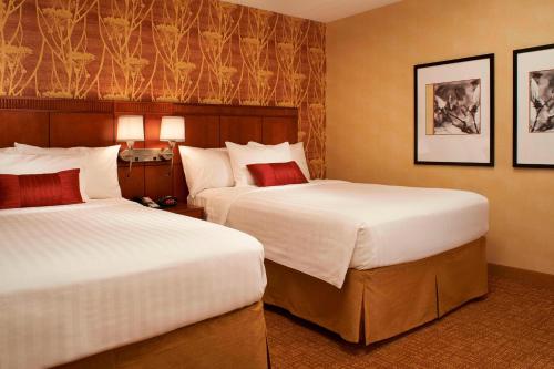 um quarto de hotel com duas camas e duas lâmpadas em Courtyard Chicago Arlington Heights/South em Arlington Heights