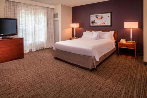 a hotel room with a bed and a flat screen tv at Residence Inn Alexandria Old Town/Duke Street in Alexandria