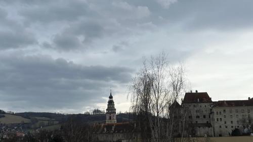a building with a clock tower in a city at Villa Gallistl in Český Krumlov