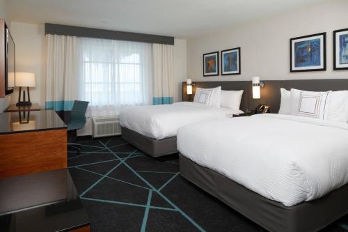 a hotel room with two beds and a window at Fairfield Inn & Suites By Marriott Camarillo in Camarillo