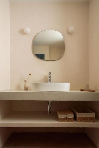 a bathroom with a sink and a mirror at Casa Uva - Boutique Stay in Vejer de la Frontera