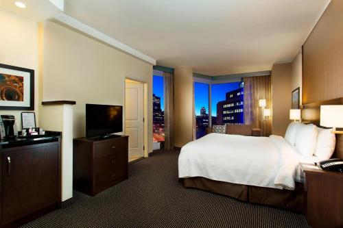 a hotel room with a bed and a television at Courtyard by Marriott Montreal Downtown in Montreal