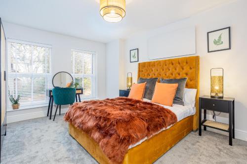a bedroom with a large bed and a table at Coppergate Mews Grimsby No7 - 2 bed, 2 bath, 1st floor apartment in Grimsby