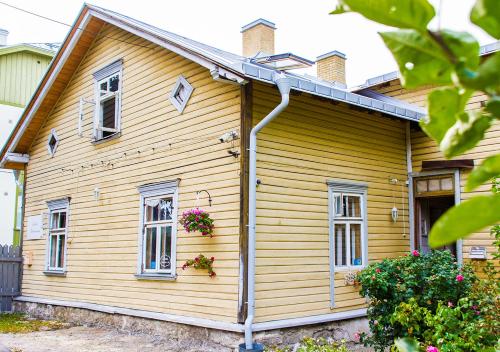 a wooden house with windows and a roof at Boutique Hotel Marta 8 in Tallinn