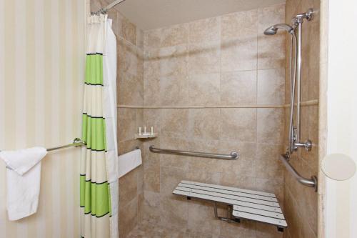 a shower with a bench in a bathroom at Fairfield Mission Viejo Orange County in Mission Viejo