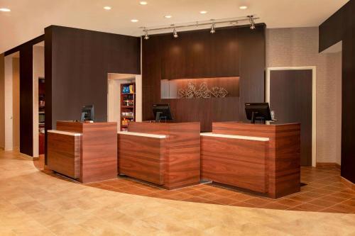 a lobby with a hair salon with wooden reception desks at Courtyard by Marriott Gaithersburg Washingtonian Center in Gaithersburg