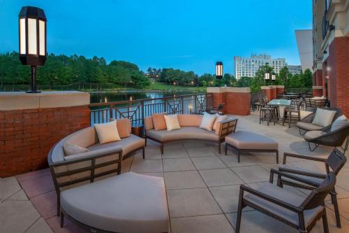 a patio with couches and chairs on a building at Courtyard by Marriott Gaithersburg Washingtonian Center in Gaithersburg