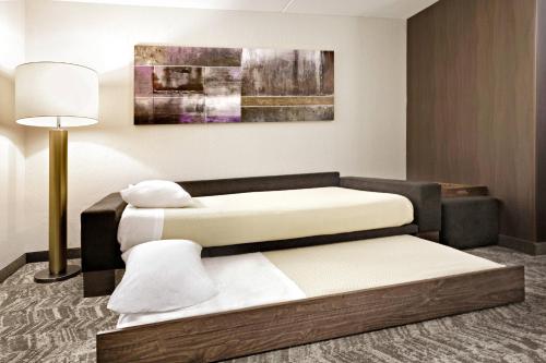 a hotel room with two beds and a lamp at SpringHill Suites Phoenix Glendale/Peoria in Peoria