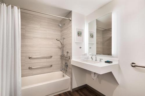 a bathroom with a tub and a sink and a shower at Aloft Mountain View in Mountain View