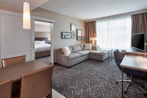 a hotel room with a couch and a bedroom at Residence Inn by Marriott Nashville Downtown/Convention Center in Nashville