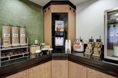 a kitchen with a counter with a refrigerator and some food at Fairfield Inn and Suites by Marriott San Antonio Boerne in Boerne