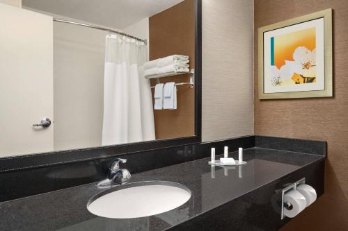 a bathroom with a sink and a mirror at Fairfield Inn & Suites Lima in Lima